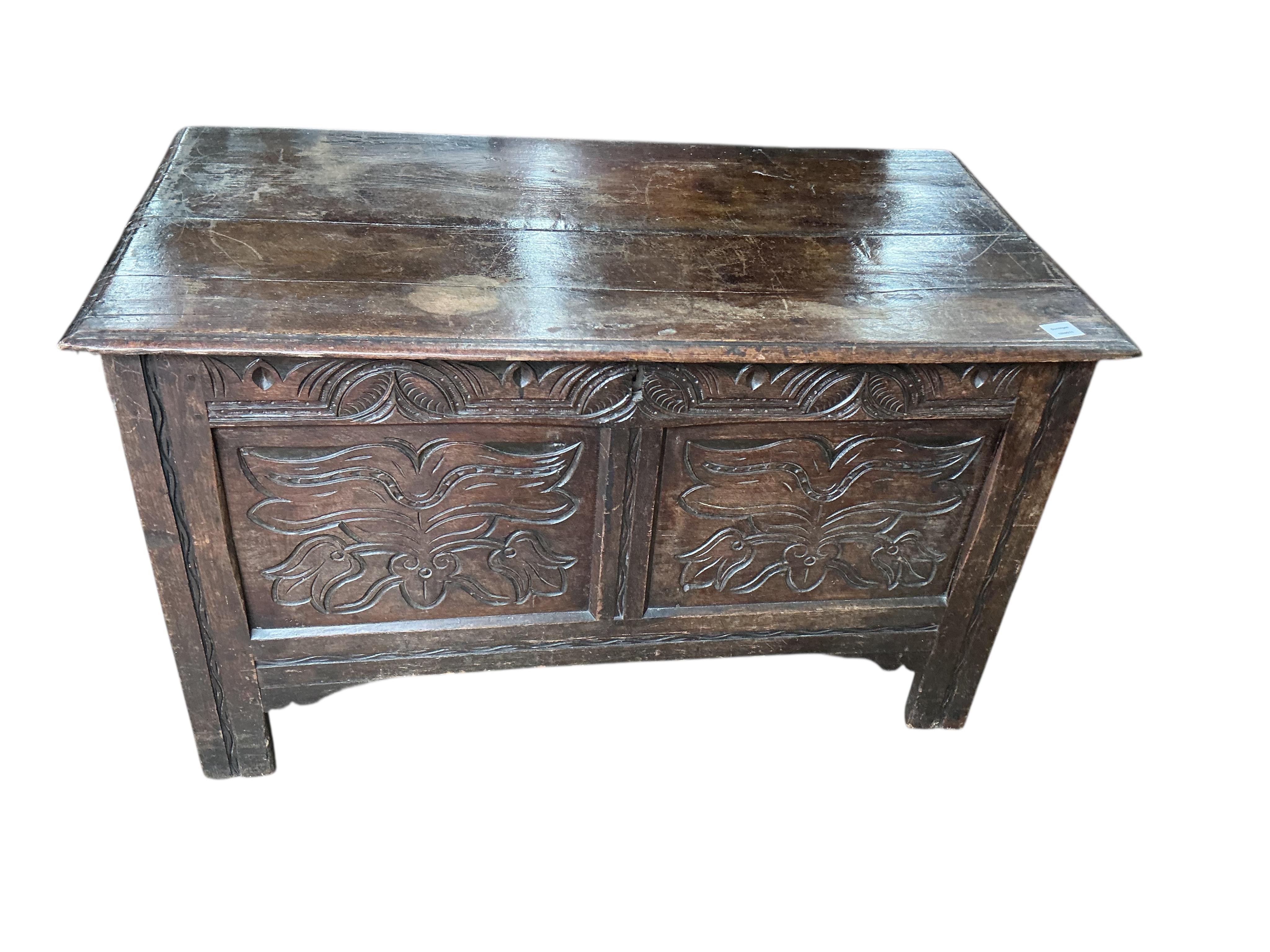 An early 18th century carved oak coffer, width 118cm
